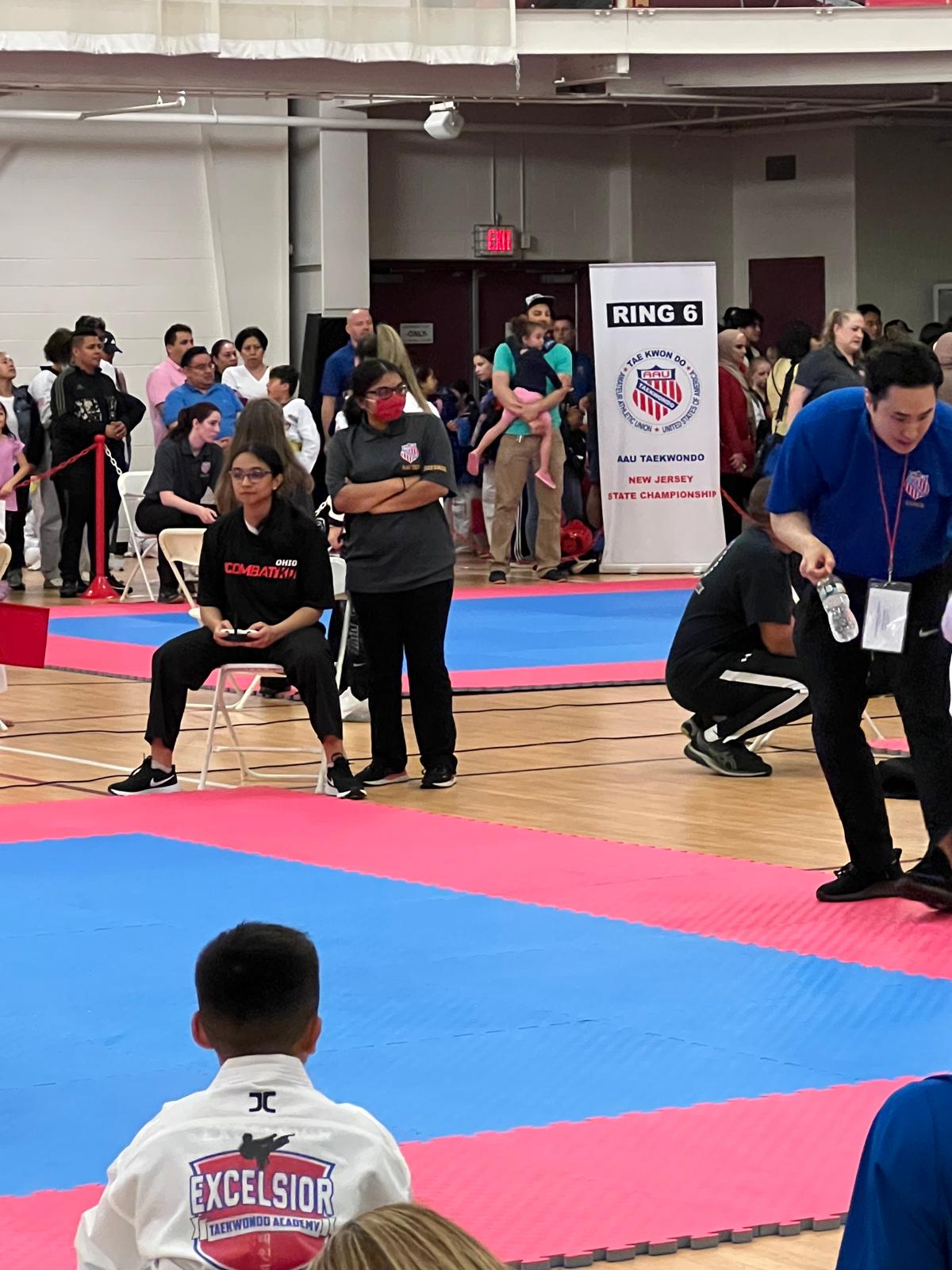 Siona participating in a martial-arts officiating setting.